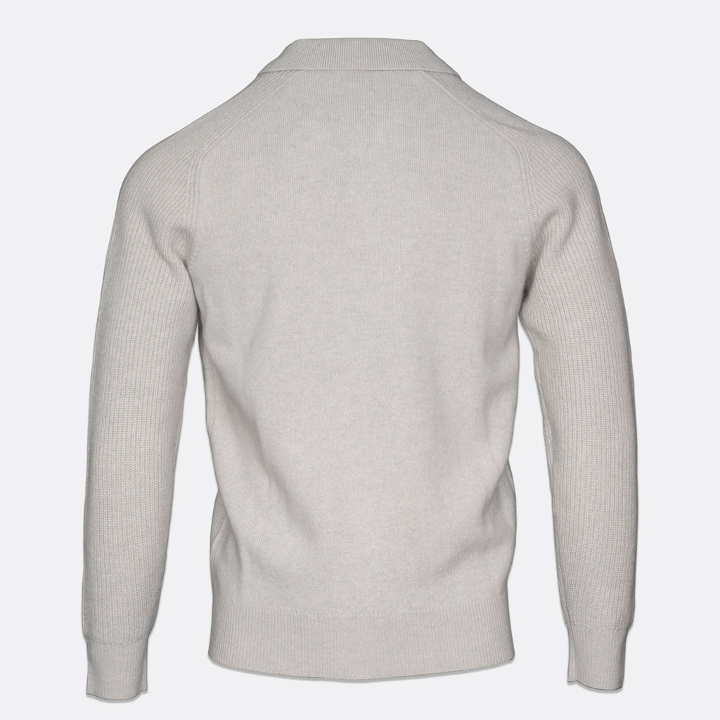 A light gray ribbed knit sweater shown from the back, featuring a classic collar and long sleeves, displayed on a clean light gray background. Thomas Maine Knitwear available at Sakks Menswear in Southampton.