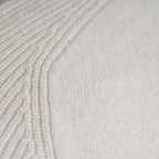 Close-up of a light cream knit fabric with a ribbed textured pattern on the left and a smoother knit section on the right. Thomas Maine Knitwear available at Sakks Menswear in Southampton.