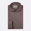 A folded men's dress shirt in a heathered dusty mauve-brown color, featuring a classic collar, button-down front, and a single-button cuff with a small embroidered red logo. The brand label inside the collar reads 'THOMAS MAINE'. Thomas Maine Shirts available at Sakks Menswear in Southampton.