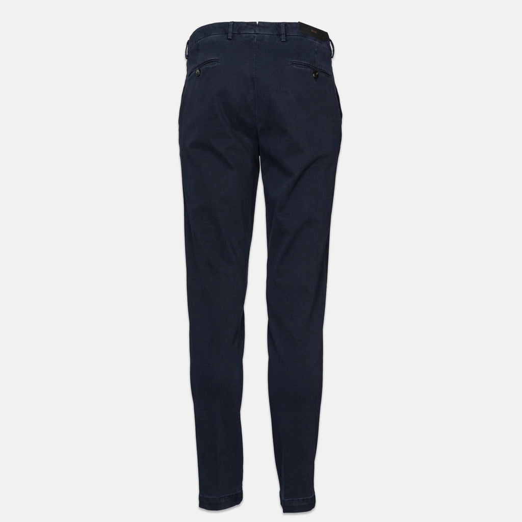 A pair of dark navy blue slim-fit trousers shown from the back, featuring a button closure and belt loops, set against a plain light gray background. Briglia 1949 Trousers available at Sakks Menswear in Southampton.