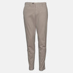 A pair of slim-fit chino pants in a light taupe-beige color, shown against a plain light gray background. Briglia 1949 trousers available at Sakks Menswear in Southampton.