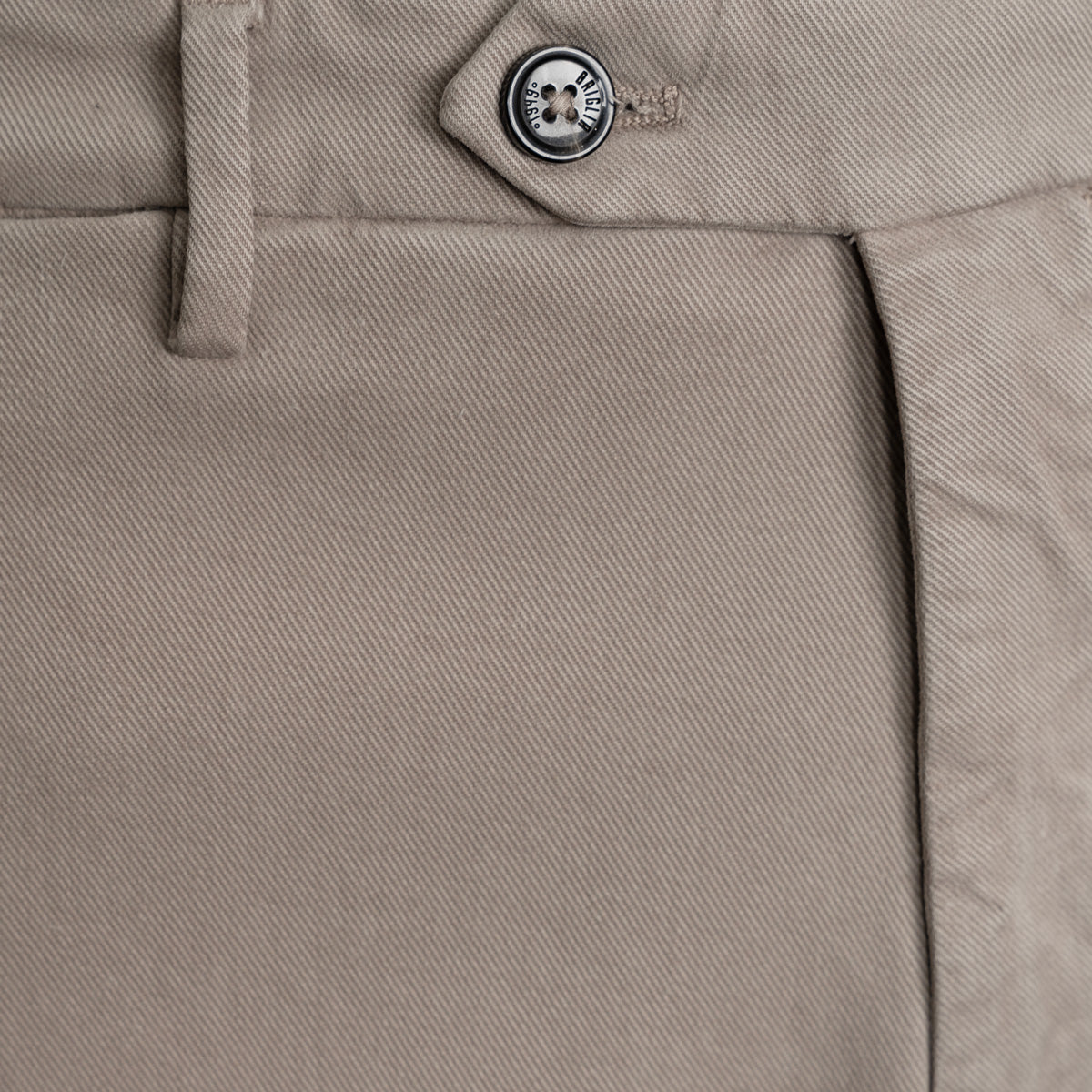 Close-up of khaki twill trousers showing the waistband, button closure, belt loop, and front seam. Briglia 1949 trousers available at Sakks Menswear in Southampton.