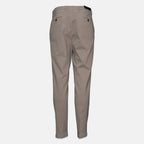 A pair of slim-fit chinos in a light taupe-beige color, shown from the back against a plain light gray background. Briglia 1949 trousers available at Sakks Menswear in Southampton.