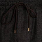Close-up of dark charcoal gray textured fabric with a dark brown drawstring and small metallic gold end caps. Briglia 1949 Trousers available at Sakks Menswear in Southampton.