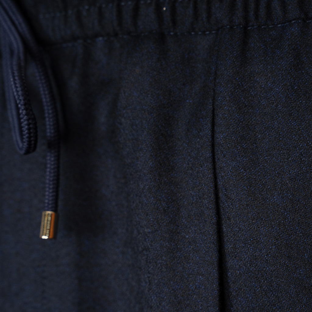 Close-up of dark navy fabric with a matching drawstring and a small metallic gold accent on the cord. Briglia 1949 Trousers available at Sakks Menswear in Southampton.