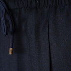 Close-up of dark navy fabric with a matching drawstring and a small metallic gold accent on the cord. Briglia 1949 Trousers available at Sakks Menswear in Southampton.