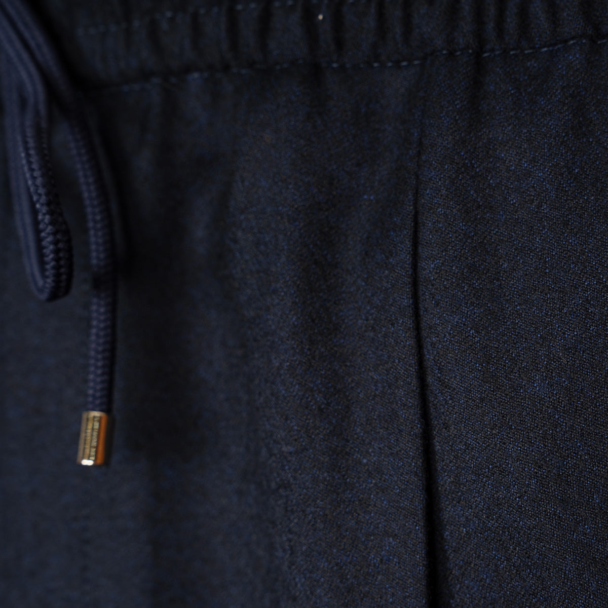 Close-up of dark navy fabric with a matching drawstring and a small metallic gold accent on the cord. Briglia 1949 Trousers available at Sakks Menswear in Southampton.