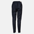 A pair of dark navy blue trousers shown from the back, featuring an elastic waistband and a small beige brand tag, set against a plain light gray background. Briglia 1949 Trousers available at Sakks Menswear in Southampton.