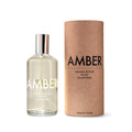 A bottle of Laboratory Perfumes No.001 Amber Eau de Toilette next to its brown kraft paper cylindrical packaging box on a white background. Laboratory Perfumes Amber available at Sakks Menswear in Southampton.