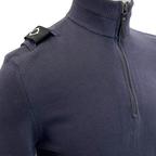 Close-up of a navy blue ribbed knit quarter-zip sweater with a black shoulder tab featuring a white geometric logo. MA.Strum Knitwear available at Sakks Menswear in Southampton.
