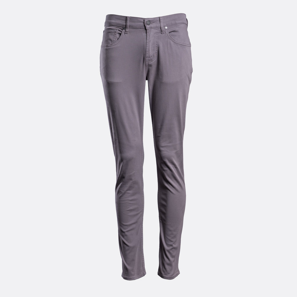 A pair of slim-fit, straight-leg jeans in a muted grayish-purple or dusty mauve color, shown against a plain light gray background. 7 For All Mankind Chinos available at Sakks Menswear in Southampton.