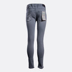A pair of slim-fit gray jeans shown from the back, featuring a dark waistband, belt loops, and a paper tag still attached to the back pocket, set against a plain light gray background. Replay Jeans available at Sakks Menswear in Southampton.
