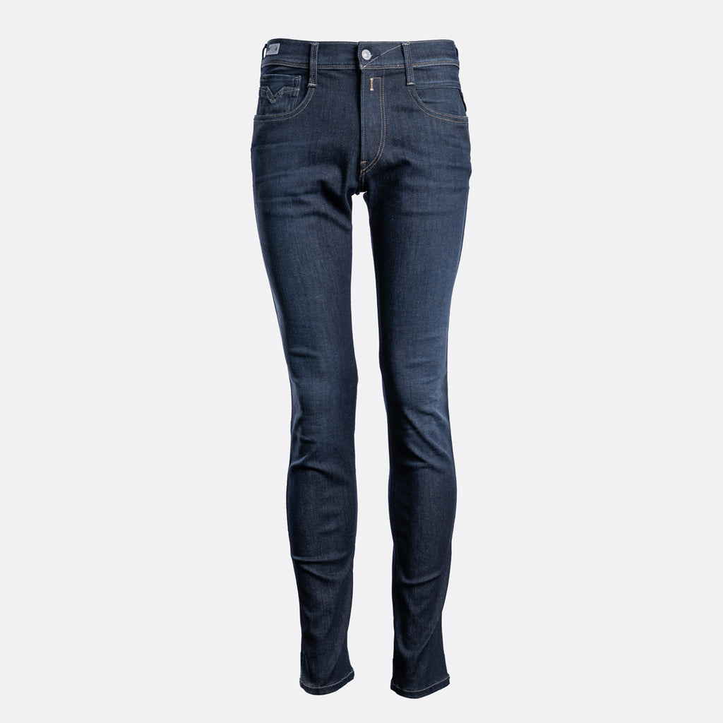 A pair of slim-fit dark blue denim jeans shown on a headless mannequin form against a light gray background. Replay Jeans available at Sakks Menswear in Southampton.