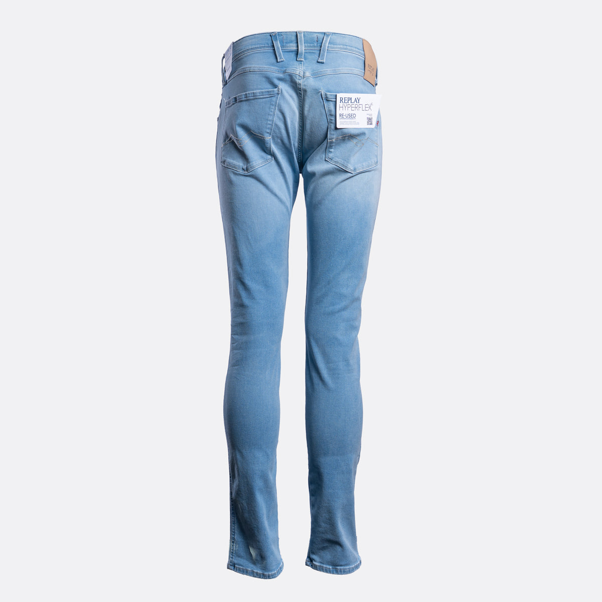 Light blue slim-fit jeans shown from the back, featuring a white brand label in the back pocket and a brown leather patch on the waistband, set against a plain light gray background. Replay Jeans available at Sakks Menswear in Southampton.