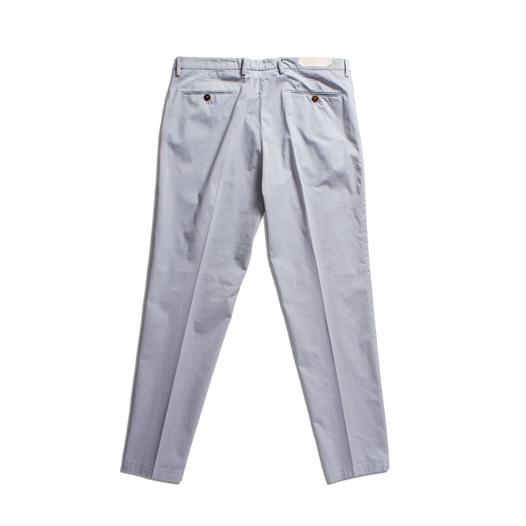 A pair of light gray slim-fit trousers shown from the back, featuring a buttoned rear pocket and a small rectangular brand patch at the waistband, laid flat against a white background. Briglia 1949 Trousers available at Sakks Menswear in Southampton.
