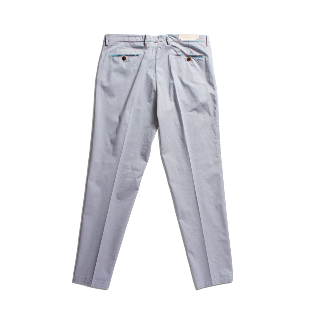 A pair of light gray slim-fit trousers shown from the back, featuring a buttoned rear pocket and a small rectangular brand patch at the waistband, laid flat against a white background. Briglia 1949 Trousers available at Sakks Menswear in Southampton.
