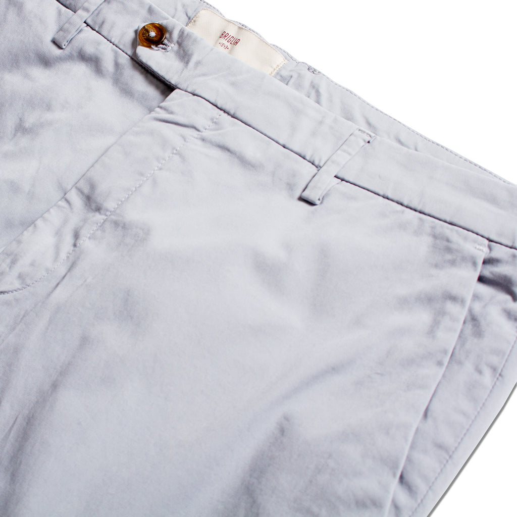 Close-up of light gray chino pants showing the waistband, belt loops, button, and front pocket stitching on a white background. Briglia 1949 Trousers available at Sakks Menswear in Southampton.