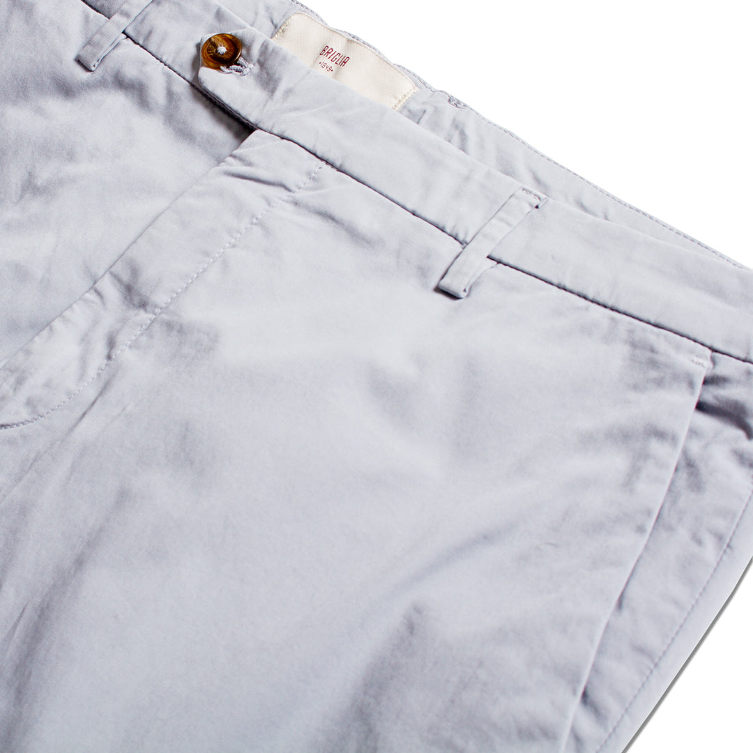 Close-up of light gray chino pants showing the waistband, belt loops, button, and front pocket stitching on a white background. Briglia 1949 Trousers available at Sakks Menswear in Southampton.