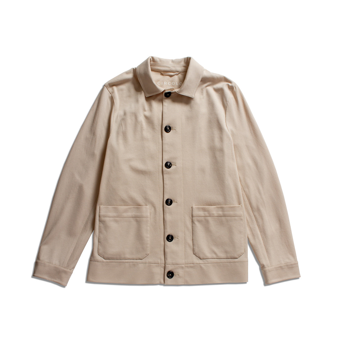 A light beige utility jacket with a pointed collar, dark buttons, and two front patch pockets, displayed flat against a white background. Circolo 1901 Shirt Jacket available at Sakks Menswear in Southampton.