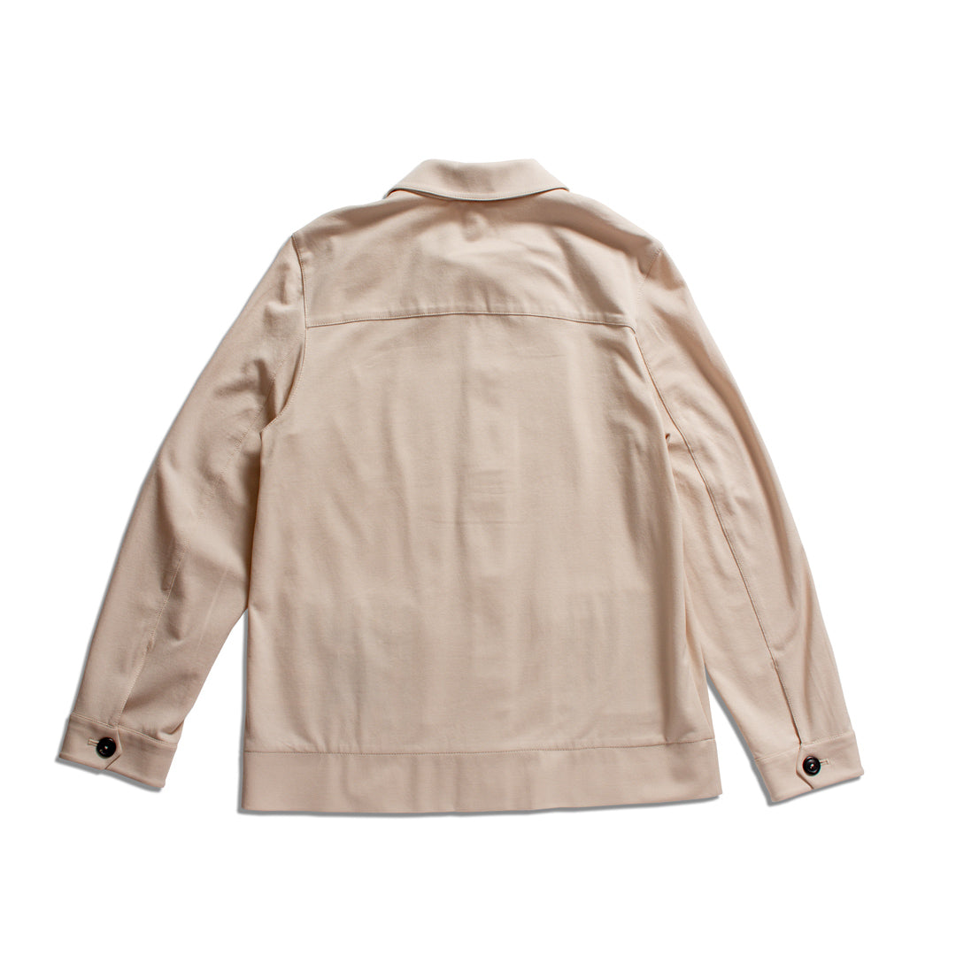 A light beige utility jacket shown from the back, featuring a pointed collar, long sleeves with buttoned cuffs, and a straight hem, laid flat against a white background. Circolo 1901 Shirt Jacket available at Sakks Menswear in Southampton.