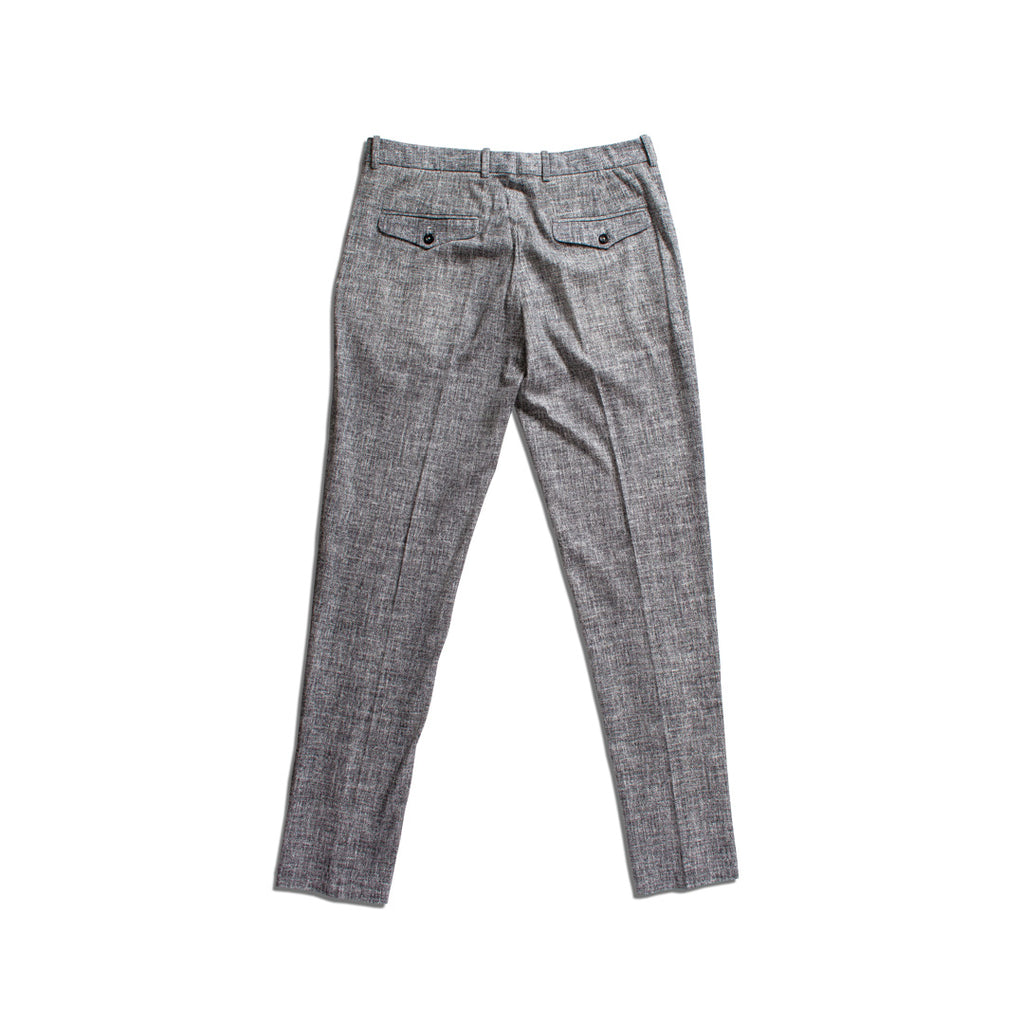 Gray textured slim-fit trousers shown from the back, featuring a subtle houndstooth or tweed-like pattern and two buttoned welt pockets. Circolo 1901 Trousers available at Sakks Menswear in Southampton.
