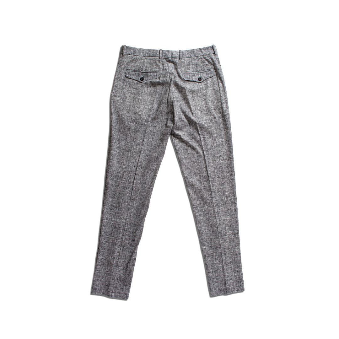 Gray textured slim-fit trousers shown from the back, featuring a subtle houndstooth or tweed-like pattern and two buttoned welt pockets. Circolo 1901 Trousers available at Sakks Menswear in Southampton.