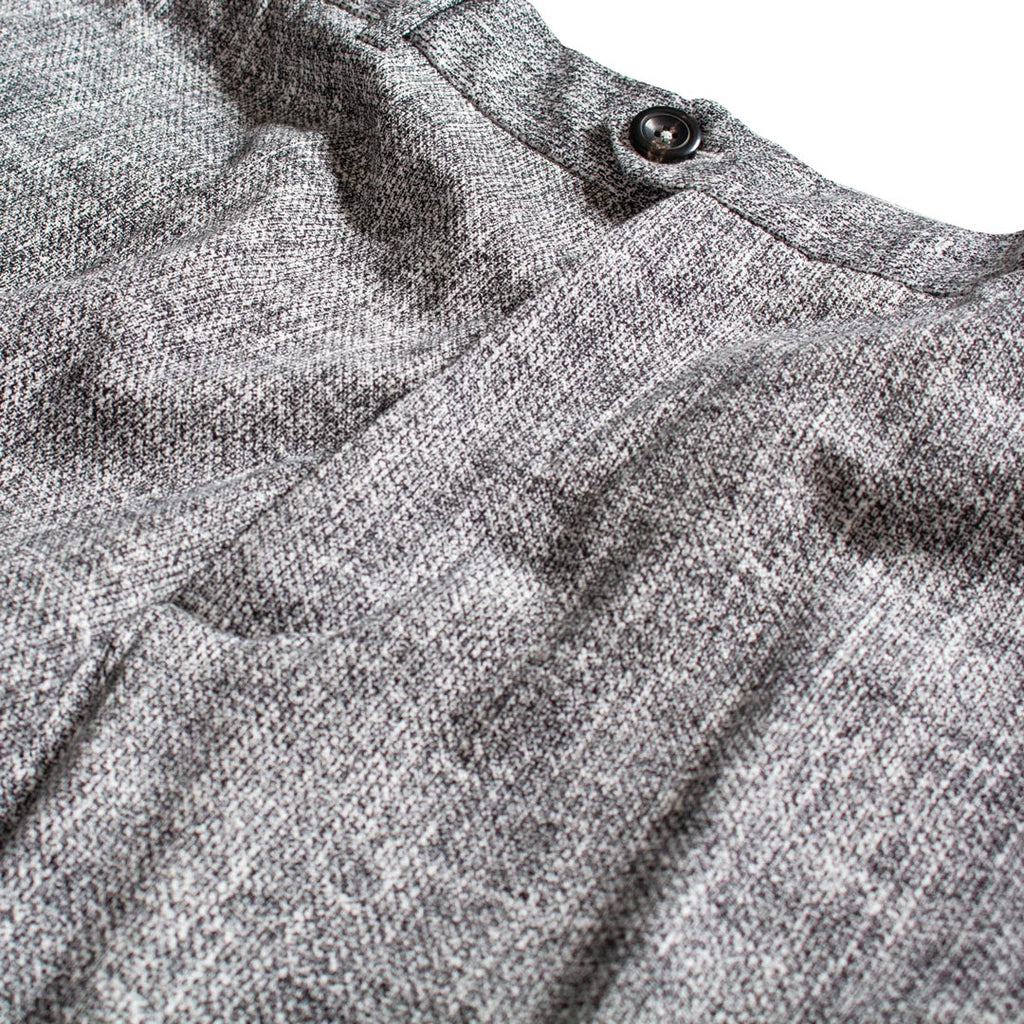Close-up of a gray heathered knit fabric garment with a dark button near the collar, shown against a white background. Circolo 1901 Trousers available at Sakks Menswear in Southampton.