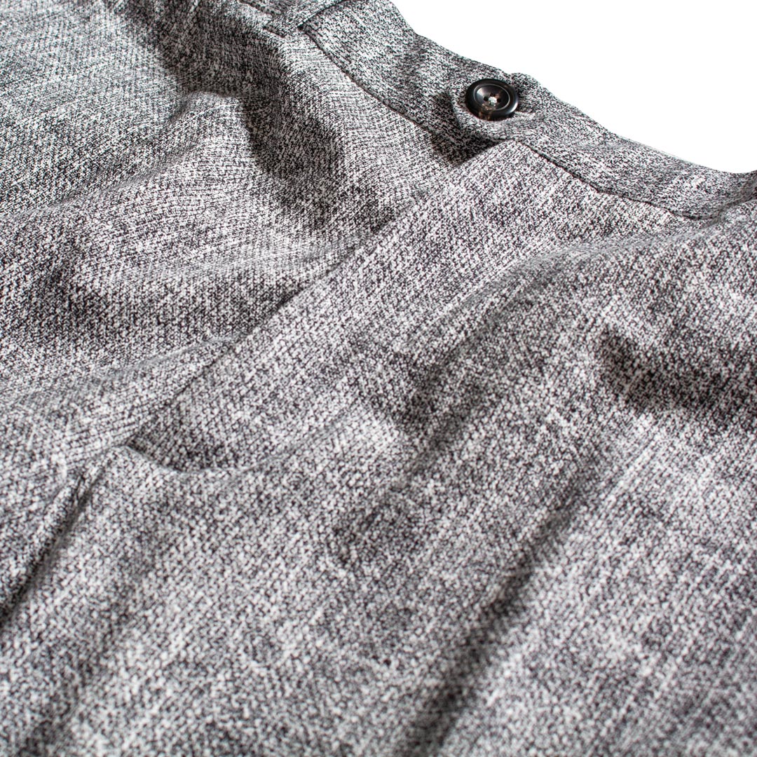 Close-up of a gray heathered knit fabric garment with a dark button near the collar, shown against a white background. Circolo 1901 Trousers available at Sakks Menswear in Southampton.