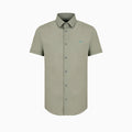 A short-sleeve button-down shirt in a muted sage green color, featuring a small embroidered bird logo on the left chest, displayed on a clean white background. Emporio Armani Short Sleeved Shirt. Sakks Menswear Southampton.