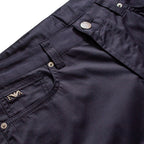 Close-up of dark navy pants showing the waistband, button closure, belt loop, front pocket, and a small embroidered logo on the pocket. Emporio Armani Shorts. Sakks Menswear Southampton.