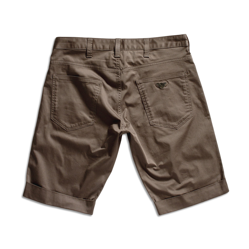 Back view of brown chino shorts with rolled cuffs, showing two back pockets and a small embroidered logo on the right pocket, set against a plain white background. Emporio Armani Shorts. Sakks Menswear Southampton.