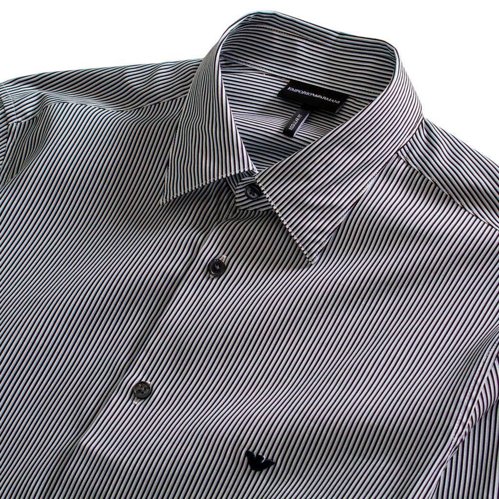 A close-up of a men's button-down shirt with a black and white micro stripe pattern, featuring a classic pointed collar and dark buttons. Emporio Armani Shirt. Sakks Menswear Southampton.
