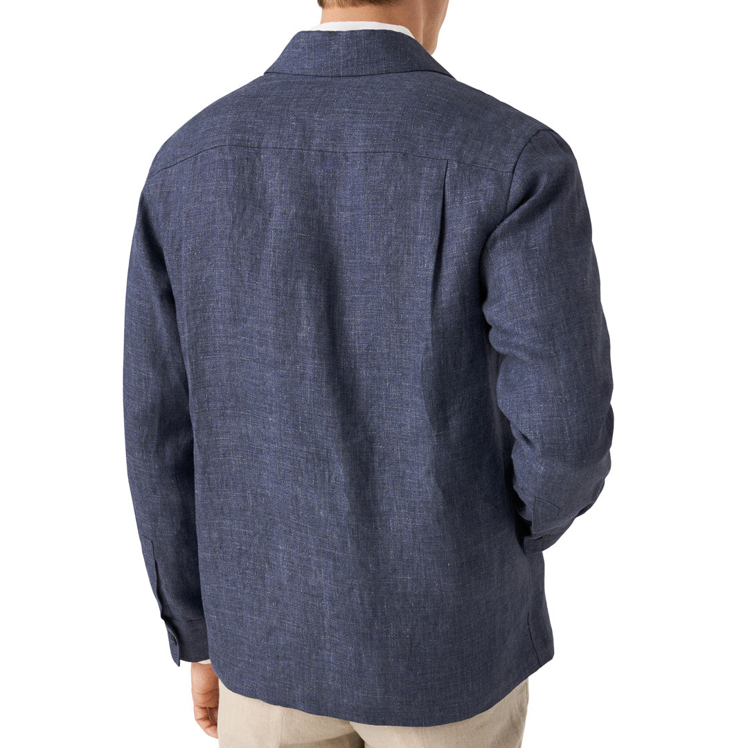 A man viewed from the back wearing a textured navy blue long-sleeve linen shirt jacket, paired with beige trousers, against a plain white background. Eton Shirt Jacket available at Sakks Menswear in Southampton.