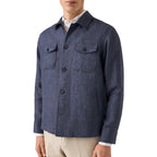 A man wearing a navy blue textured button-up shirt jacket over a white collared shirt and beige trousers, shown from the chin down against a plain white background. Eton Shirt Jacket available at Sakks Menswear in Southampton.