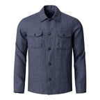 A men's long-sleeve button-up shirt in a textured blue-grey fabric, featuring a classic collar, dark buttons, and two buttoned chest flap pockets, shown against a plain white background. Eton Shirt Jacket available at Sakks Menswear in Southampton.