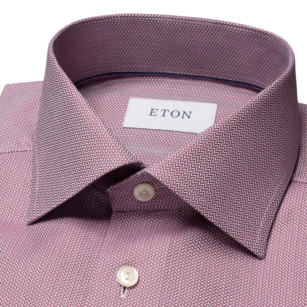 Close-up of a men's dress shirt collar in a dusty mauve pink and gray herringbone pattern, featuring a white neck label with the brand name ETON. Eton Shirt available at Sakks Menswear in Southampton.