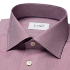 Close-up of a men's dress shirt collar in a dusty mauve pink and gray herringbone pattern, featuring a white neck label with the brand name ETON. Eton Shirt available at Sakks Menswear in Southampton.
