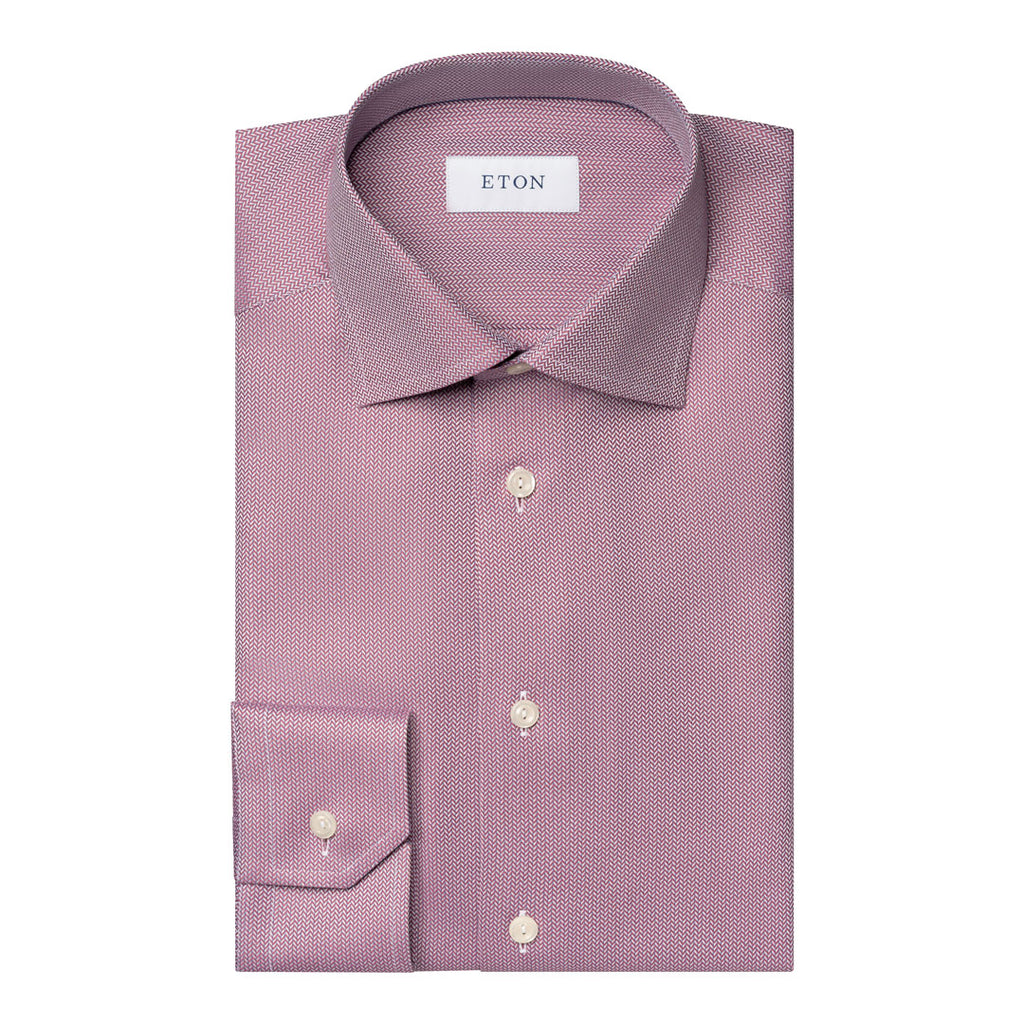 A folded ETON brand dress shirt in a dusty mauve-purple color with a subtle micro-texture, featuring a spread collar, button-down front, and a single-button cuff. Eton Shirt available at Sakks Menswear in Southampton.