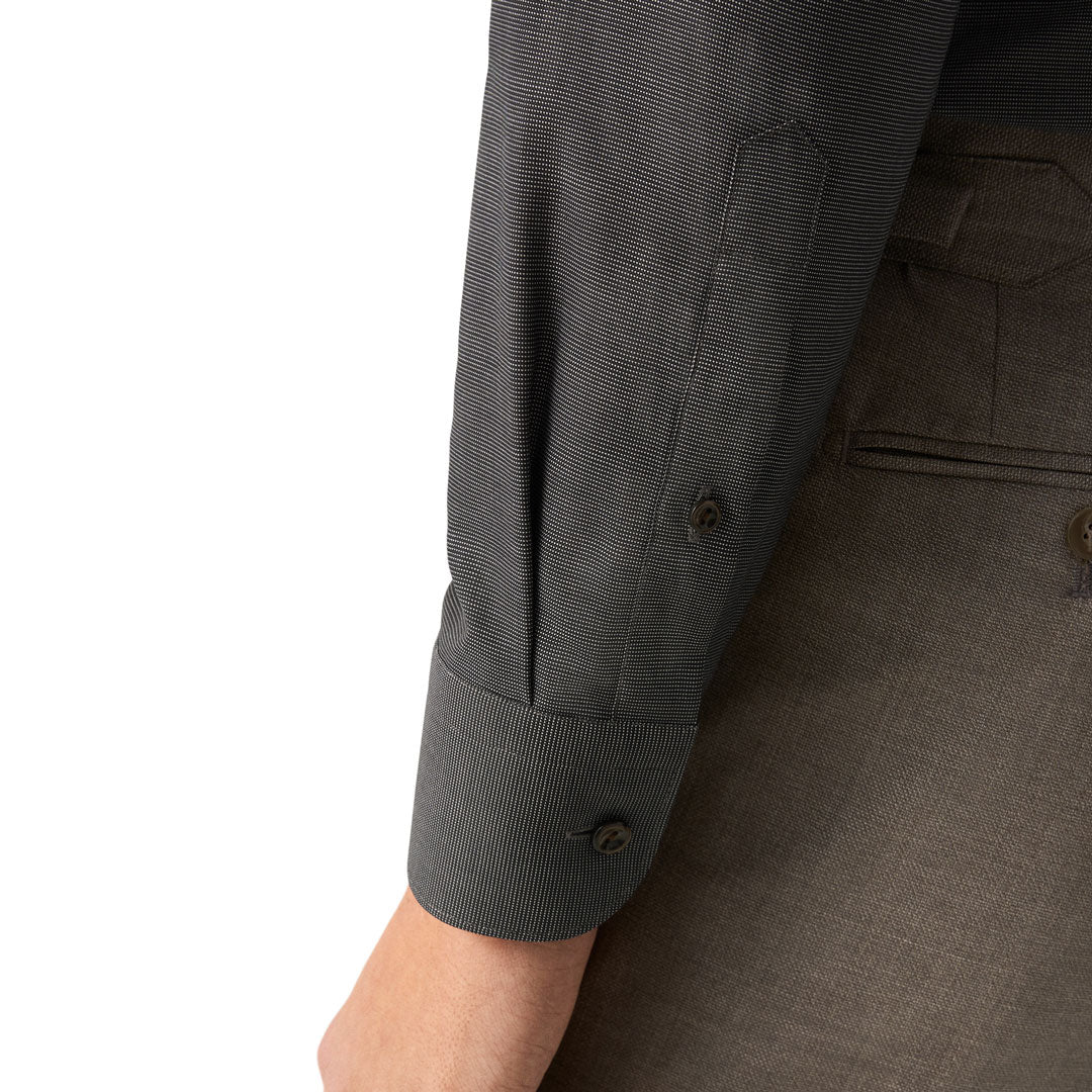 Close-up of a dark gray textured long-sleeve shirt with a buttoned cuff, worn with matching gray trousers against a white background. Eton Shirt available at Sakks Menswear in Southampton.