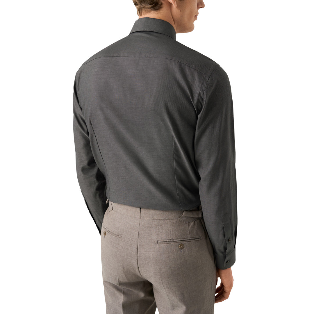 A man shown from the back wearing a dark charcoal gray long-sleeve dress shirt and light gray trousers, against a plain white background. Eton Shirt available at Sakks Menswear in Southampton.