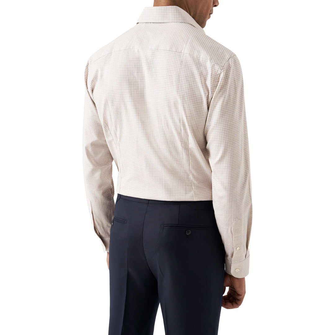A man shown from the back wearing a light beige and white micro-check patterned dress shirt with dark navy trousers, against a plain white background. Eton Shirt available at Sakks Menswear in Southampton.
