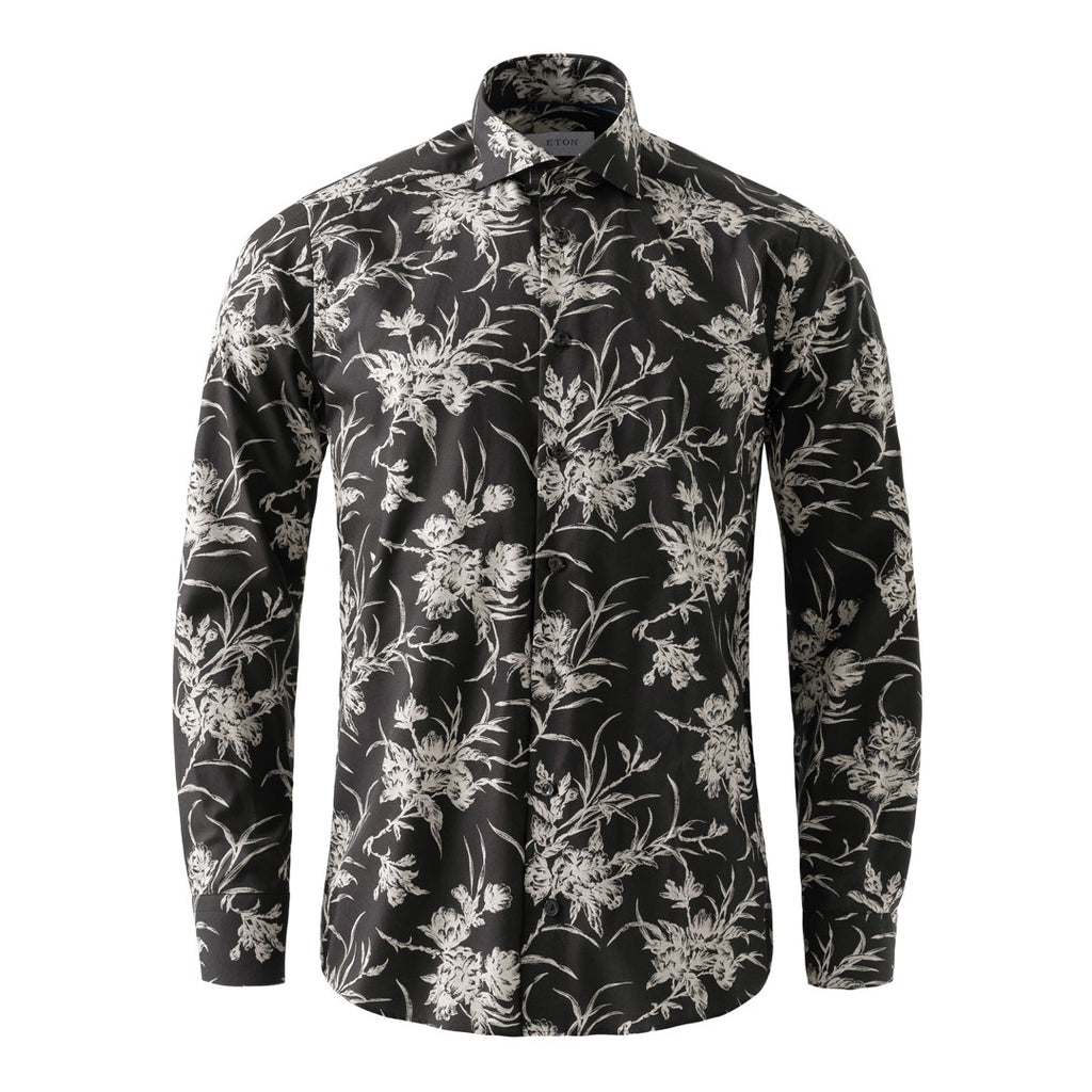 A long-sleeve button-up shirt with a black base and an all-over white floral and botanical print, displayed on a clean white background. Eton Shirt available at Sakks Menswear in Southampton.