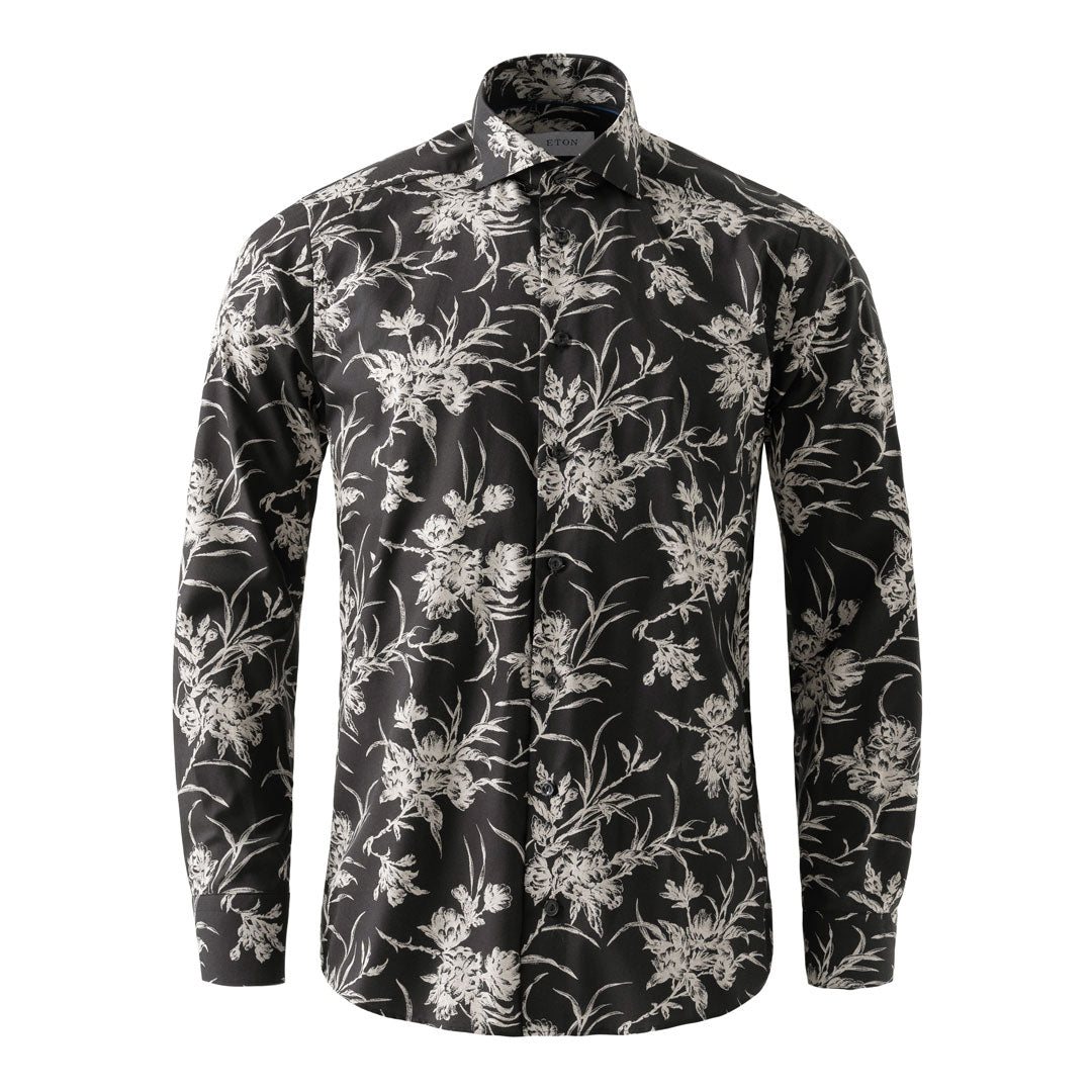 A long-sleeve button-up shirt with a black base and an all-over white floral and botanical print, displayed on a clean white background. Eton Shirt available at Sakks Menswear in Southampton.