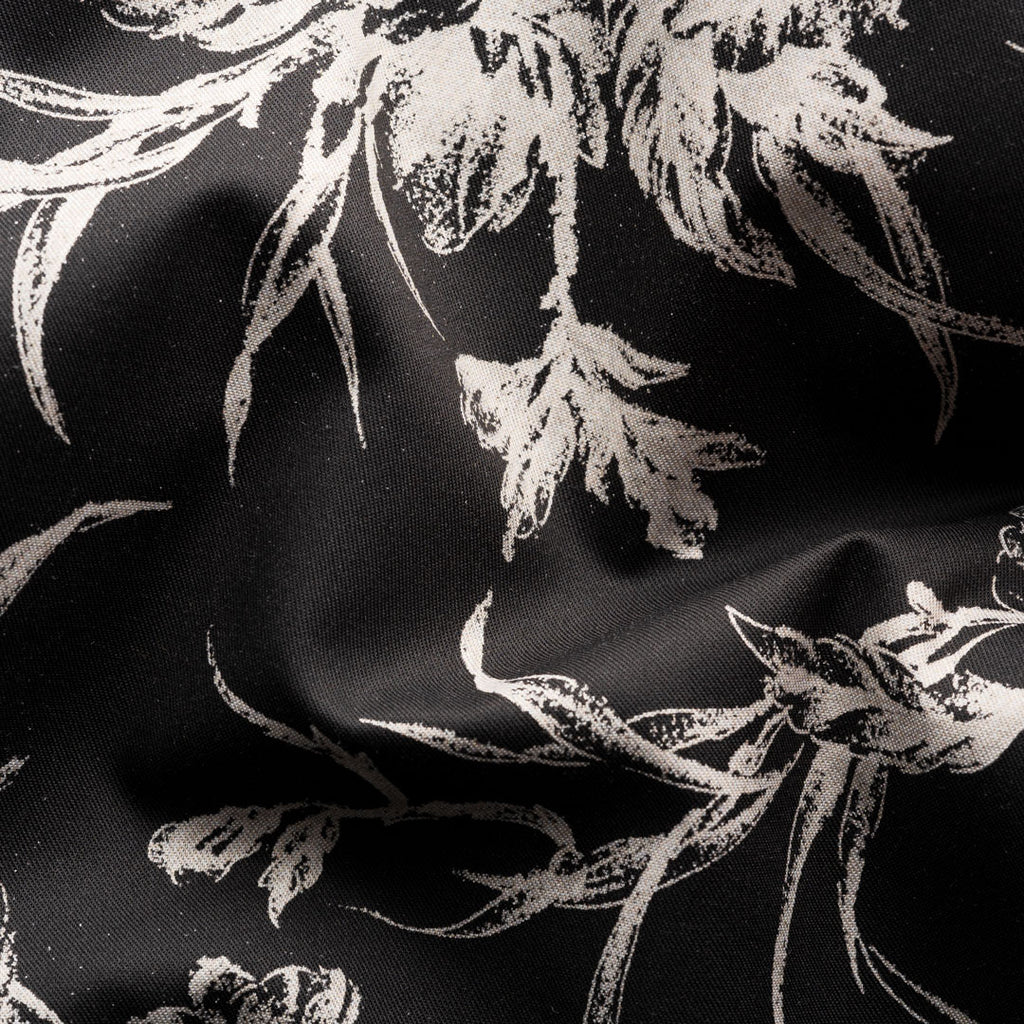 Black fabric with a distressed white floral pattern, shown in a close-up with soft folds. Eton Shirt available at Sakks Menswear in Southampton.