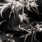 Black fabric with a distressed white floral pattern, shown in a close-up with soft folds. Eton Shirt available at Sakks Menswear in Southampton.