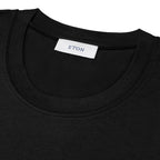 Close-up of a black crew-neck t-shirt showing the inner neck label which reads 'ETON'.Eton T-Shirt available at Sakks Menswear in Southampton.
