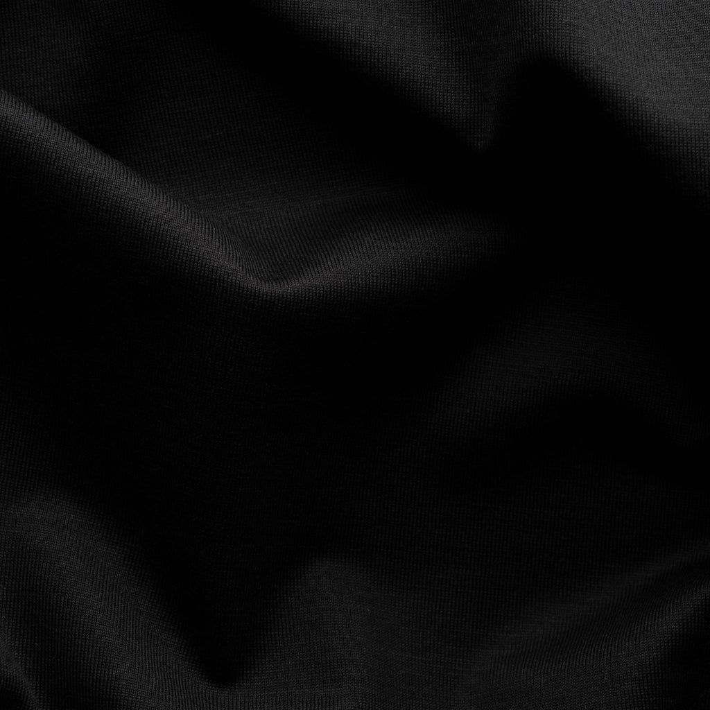 A close-up of black fabric with soft folds and a smooth texture. Eton T-Shirt available at Sakks Menswear in Southampton.