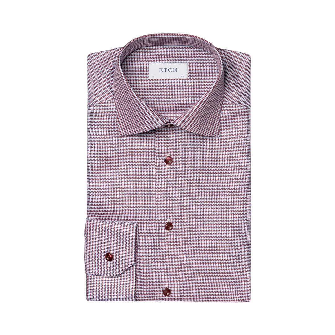 A folded ETON men's dress shirt with a fine micro-pattern of small pink and white dots, featuring dark brown buttons and a white neck label. Eton Shirt available at Sakks Menswear in Southampton.