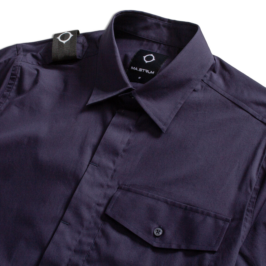 Close-up of a dark navy button-up shirt by Maistrún, showing the collar, chest pocket, and shoulder tab against a white background. MA.Strum Short Sleeve Shirt available at Sakks Menswear in Southampton.