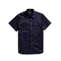 A dark navy blue short-sleeve button-up shirt with a chest pocket and shoulder epaulets, displayed flat against a white background. MA.Strum Short Sleeve Shirt available at Sakks Menswear in Southampton.